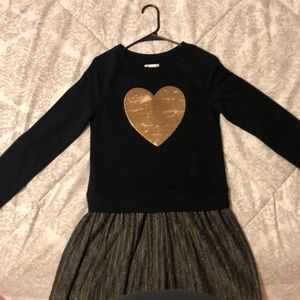 this is a black dress with a golden heart